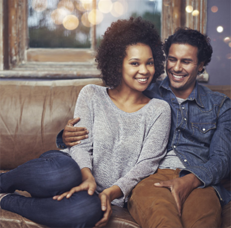 smiling couple on a couch